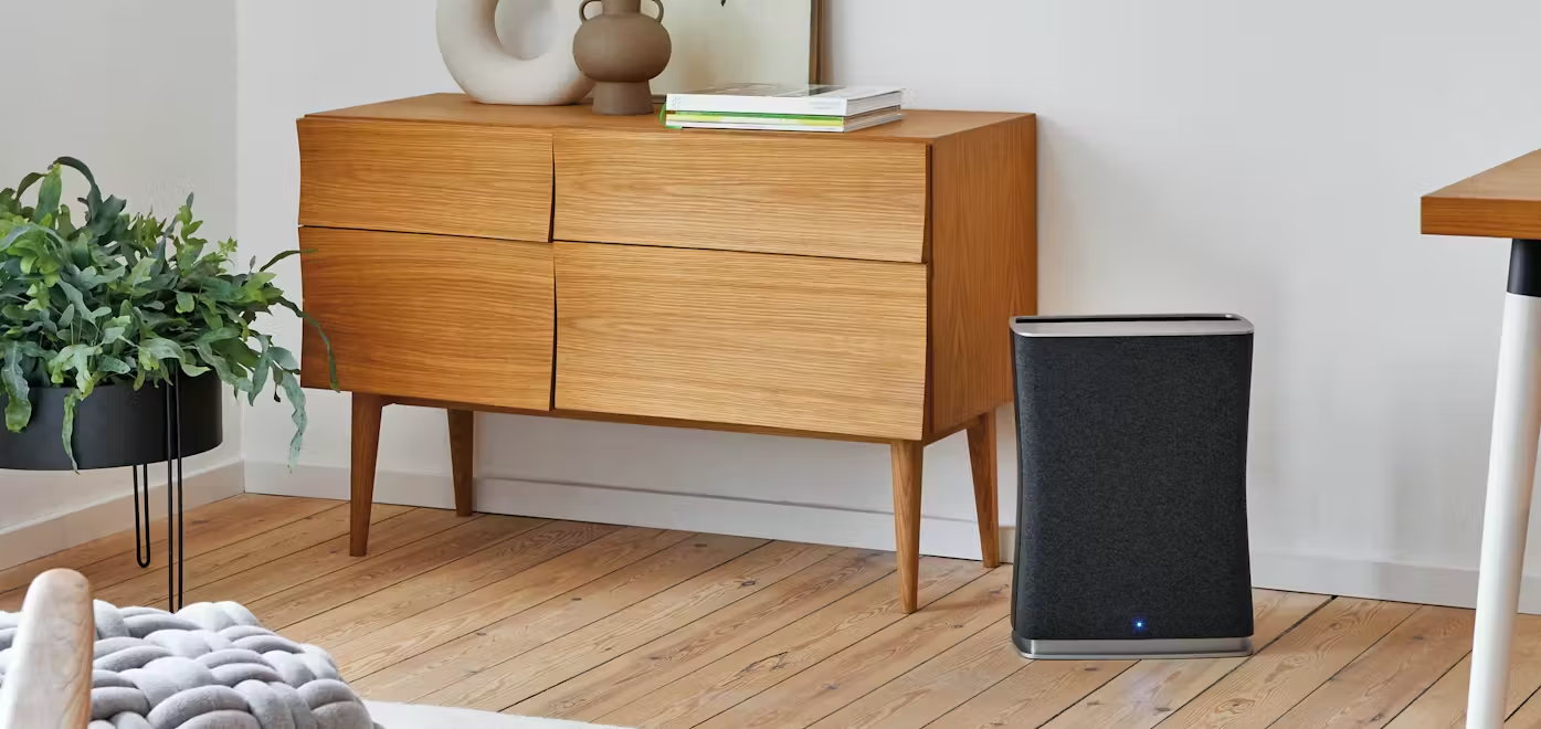 Stadler Form Roger little air purifier next to a sideboard