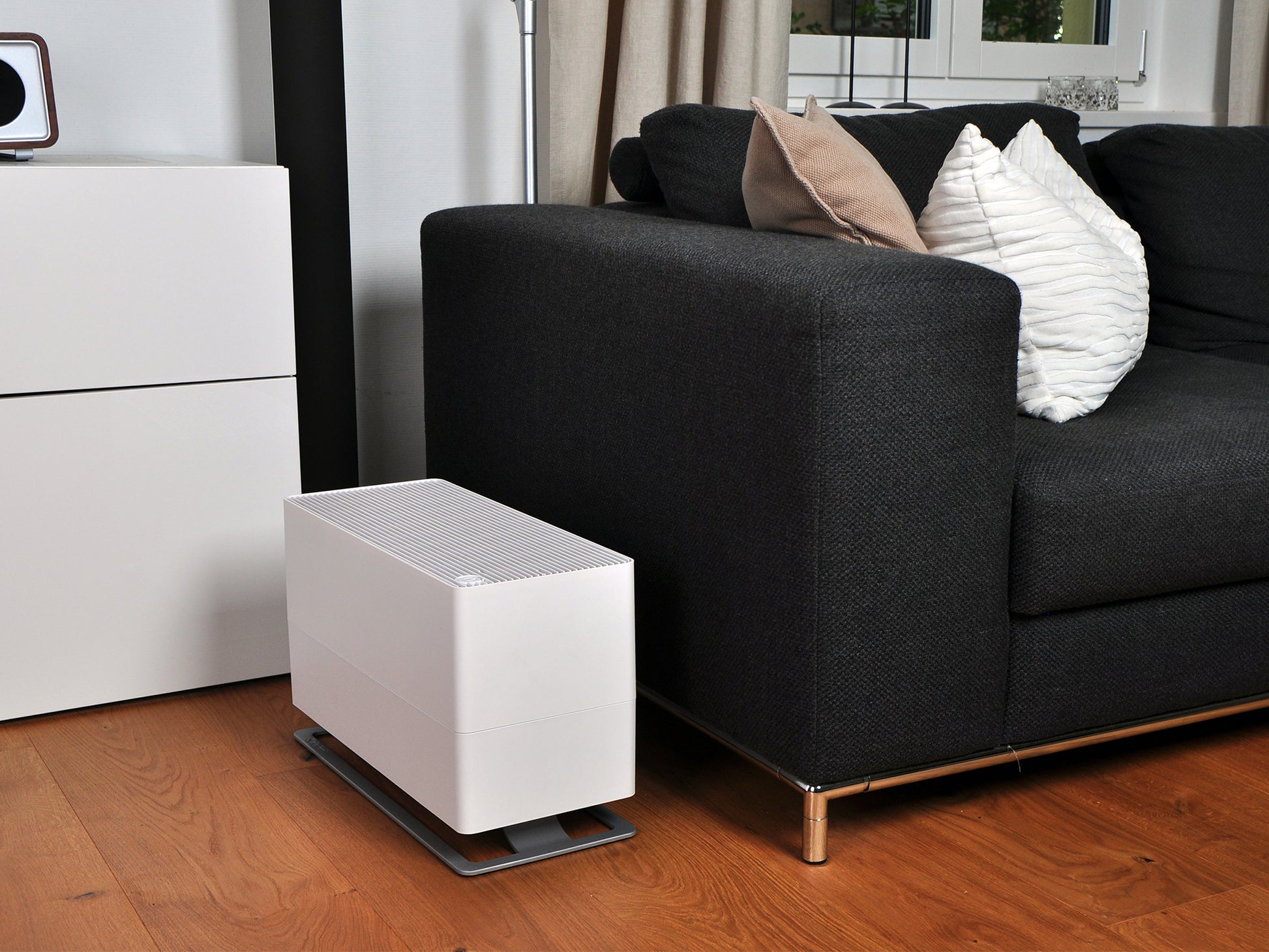 Stadler Form Oskar big humidifier in white next to a couch